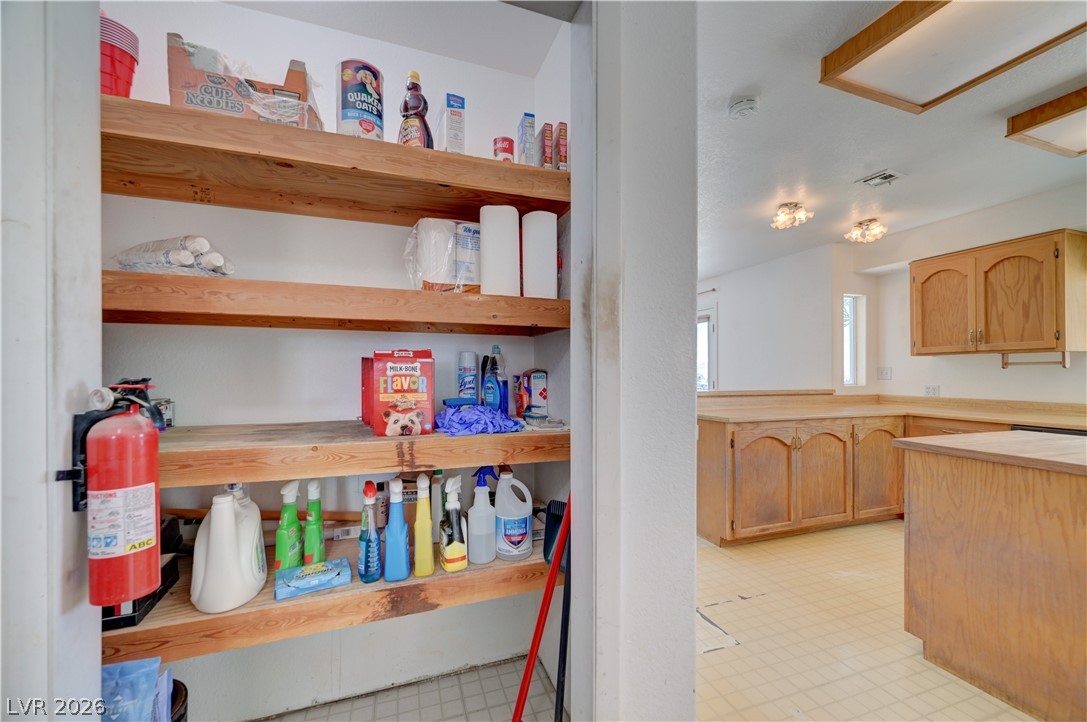590 East Encinitas Street Searchlight, NV 89046 - Photo 17 of 39 This spacious pantry provides abundant storage, while the adjacent kitchen features classic wooden cabinetry.