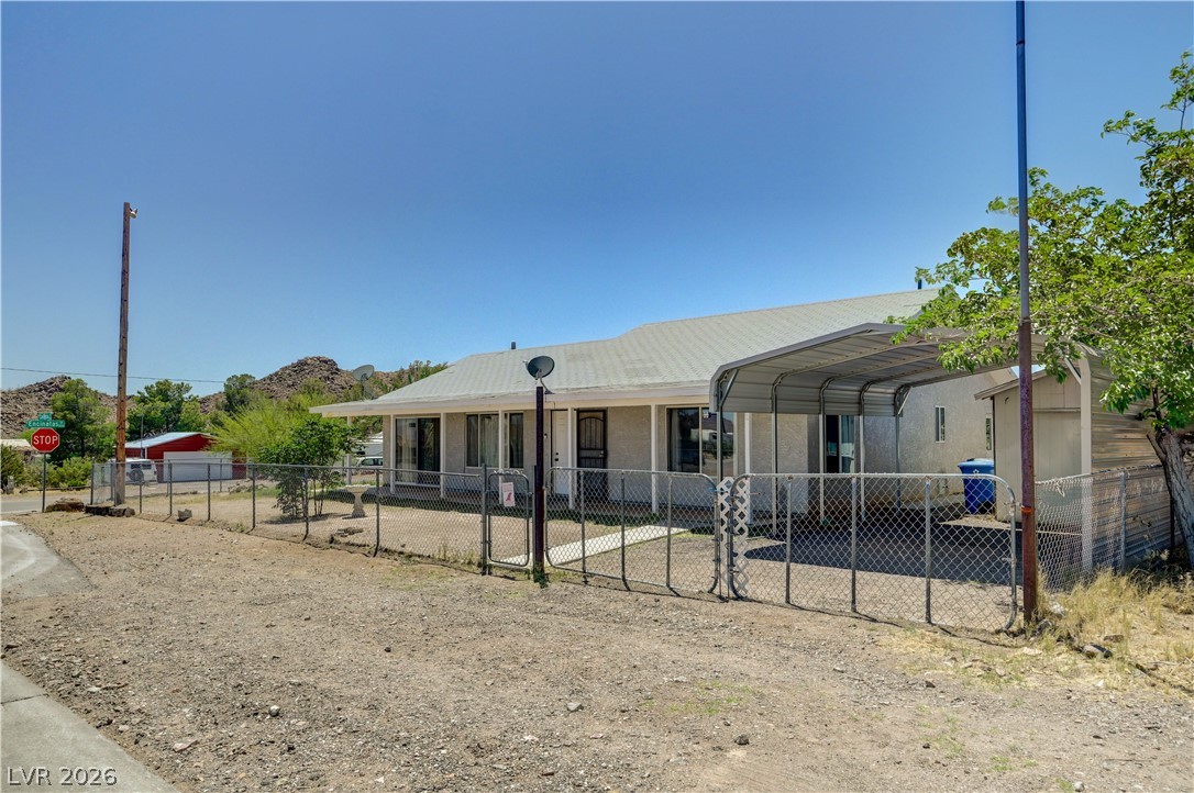590 East Encinitas Street Searchlight, NV 89046 - Photo 18 of 39 This charming residence offers a carport and chain link fence, perfect for comfortable living.