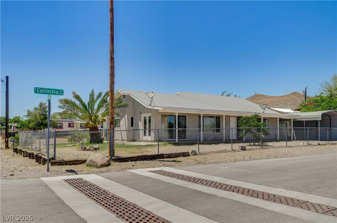 590 East Encinitas Street Searchlight, NV 89046 - Photo 19 of 39 This desert dwelling offers convenient street access and mountain views under a vast blue sky.