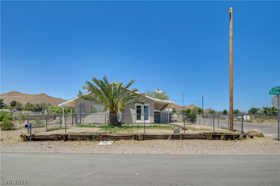 590 East Encinitas Street Searchlight, NV 89046 - Photo 20 of 39 This charming residence is nestled against a serene mountain backdrop, offering a peaceful retreat.