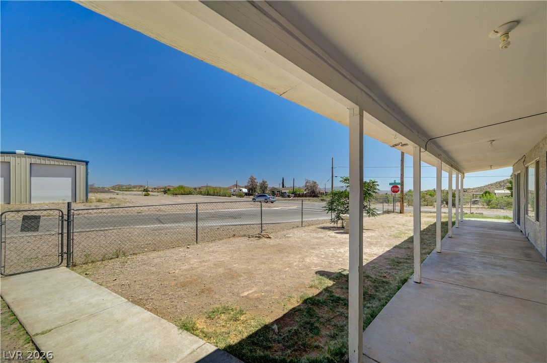 590 East Encinitas Street Searchlight, NV 89046 - Photo 25 of 39 This desert property features a covered porch, offering expansive views of the surrounding landscape.