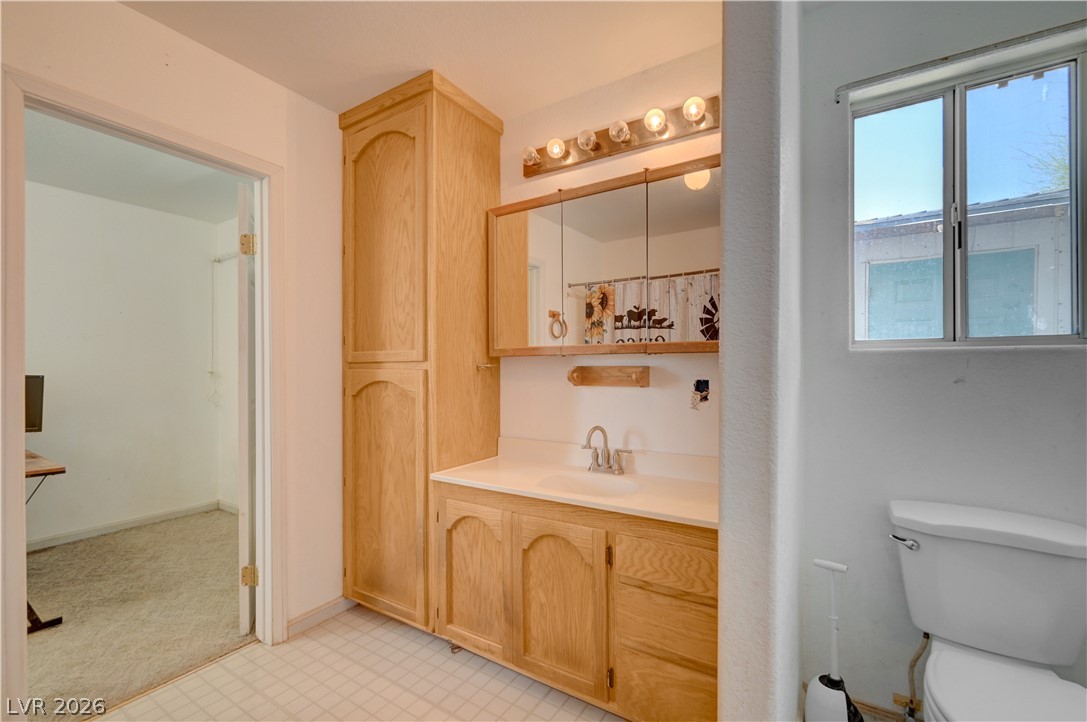 590 East Encinitas Street Searchlight, NV 89046 - Photo 32 of 39 This bright bathroom features a spacious vanity with ample storage and a window for natural light.