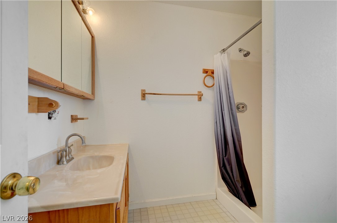 590 East Encinitas Street Searchlight, NV 89046 - Photo 35 of 39 This bathroom features a functional vanity and a clean shower area.