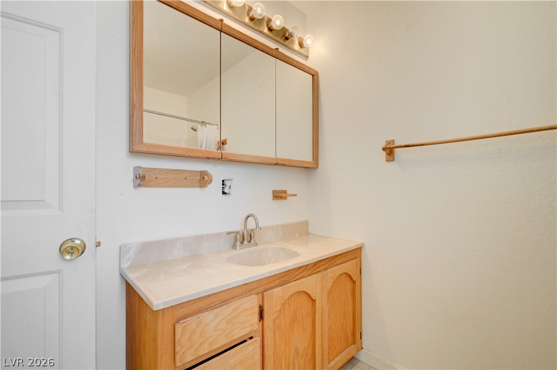 590 East Encinitas Street Searchlight, NV 89046 - Photo 36 of 39 This bathroom features a functional vanity with ample storage, offering practicality and convenience.