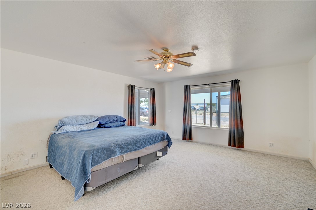 590 East Encinitas Street Searchlight, NV 89046 - Photo 6 of 39 This airy bedroom offers a comfortable retreat with ample natural light.