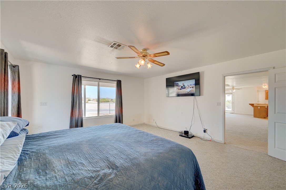 590 East Encinitas Street Searchlight, NV 89046 - Photo 7 of 39 This spacious bedroom offers ample natural light and plush carpeting for comfort.