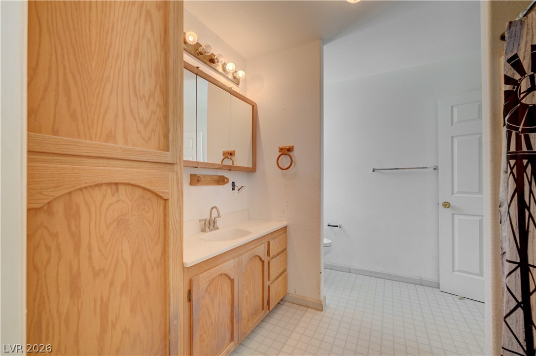 590 East Encinitas Street Searchlight, NV 89046 - Photo 8 of 39 This clean and functional bathroom features ample cabinetry and a well-lit vanity.