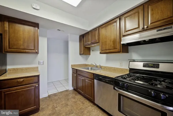 a kitchen with stainless steel appliances granite countertop a stove and a microwave