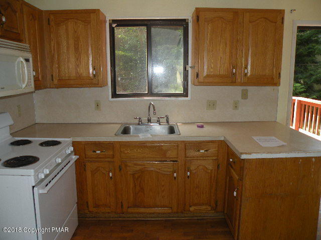 703 Edgewood Road Tobyhanna, PA 18466 - Photo 2 of 17 a kitchen with a sink and cabinets