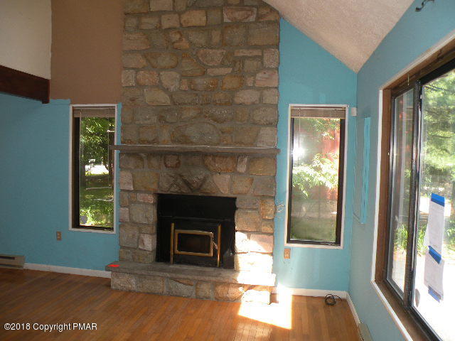 703 Edgewood Road Tobyhanna, PA 18466 - Photo 5 of 17 a view of a livingroom with a fireplace and window