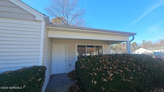 a view of a house with brick walls and a yard