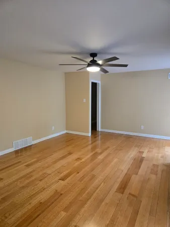 a view of an empty room and wooden floor