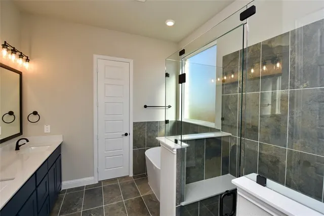 a bathroom with a double vanity sink a toilet and shower