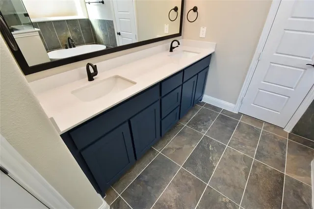 a bathroom with a sink and mirror