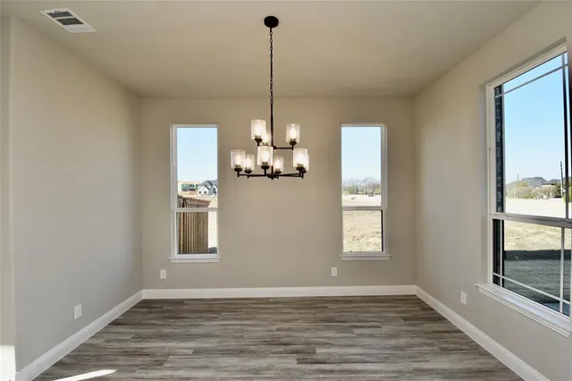a view of a room with window wooden floor and chandelier