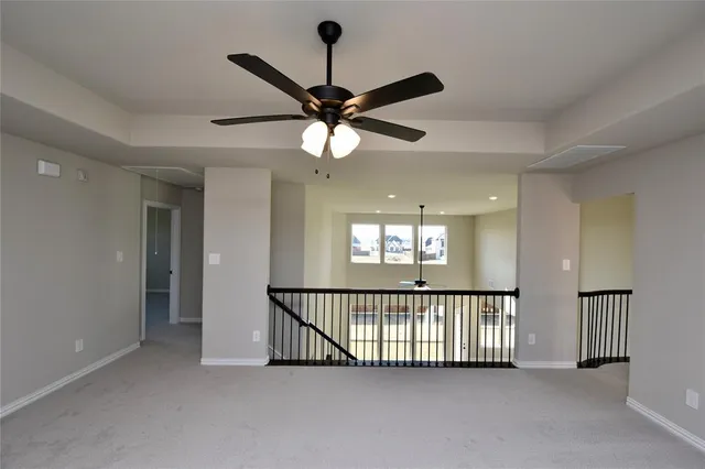a view of a livingroom with a ceiling fan and window