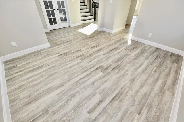 a view of a room with wooden floor and stairs