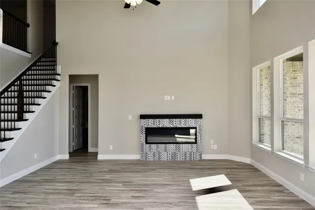 a view of a livingroom with wooden floor and a fireplace