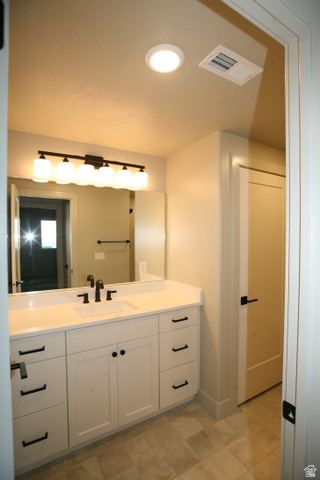 635 East Mountain Road North Ogden, UT 84414 - Photo 14 of 33 Bathroom vanity featuring a single rectangular undermount sink, a white countertop, and matte black fixtures
