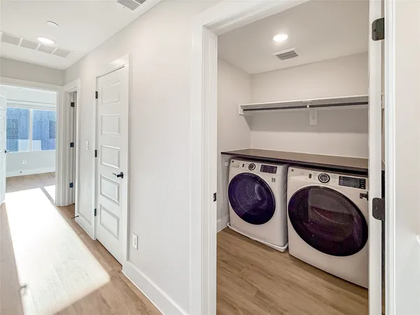 a view of a hallway with washer and dryer
