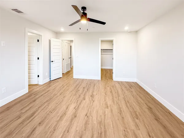 a view of empty room with wooden floor