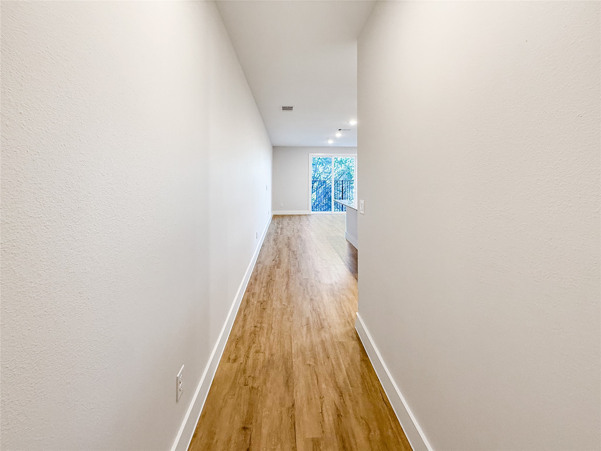 5605 Mobeetie Loop Bee Cave, TX 78738 - Photo 3 of 23 a view of a hallway with wooden floor