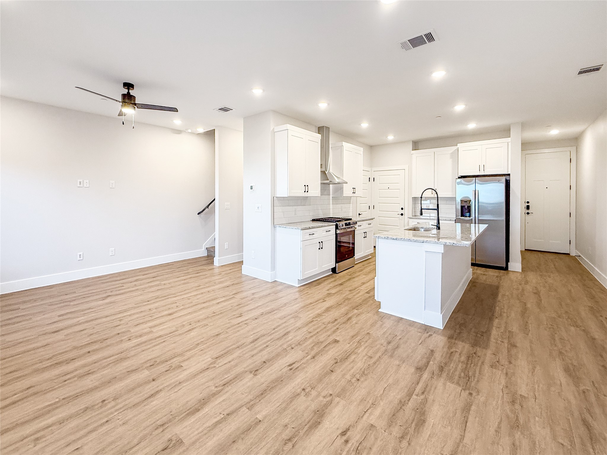 5605 Mobeetie Loop Bee Cave, TX 78738 - Photo 5 of 23 a view of kitchen view wooden floors appliances and cabinets