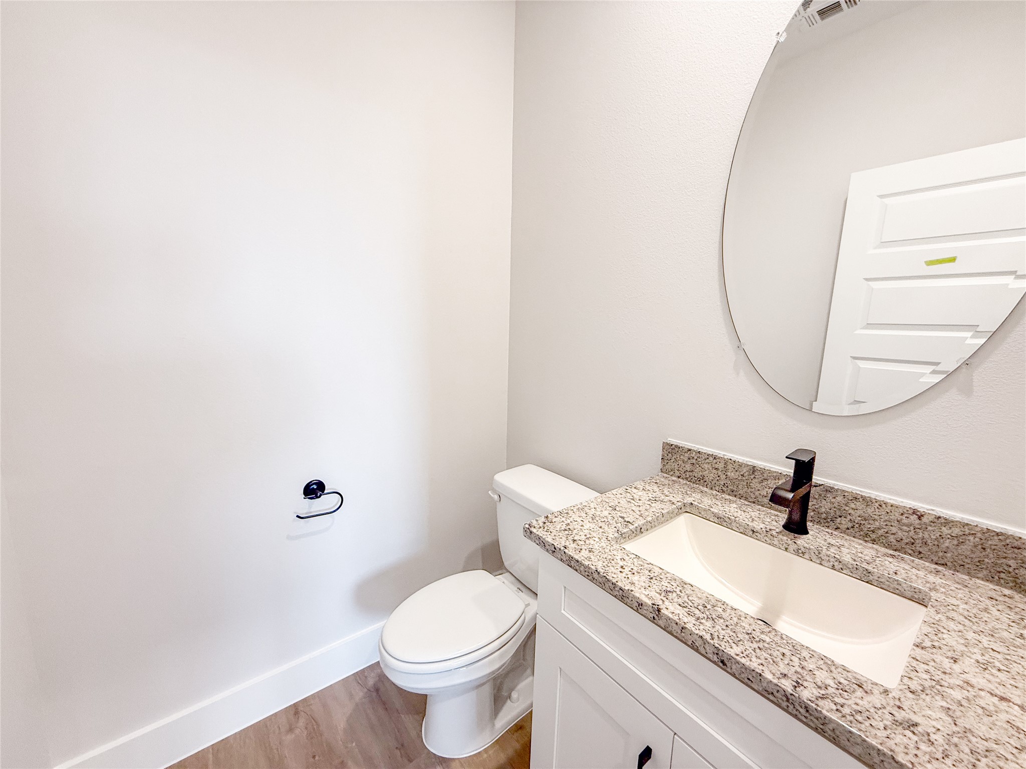 5605 Mobeetie Loop Bee Cave, TX 78738 - Photo 10 of 23 a bathroom with a granite countertop sink a toilet and a mirror