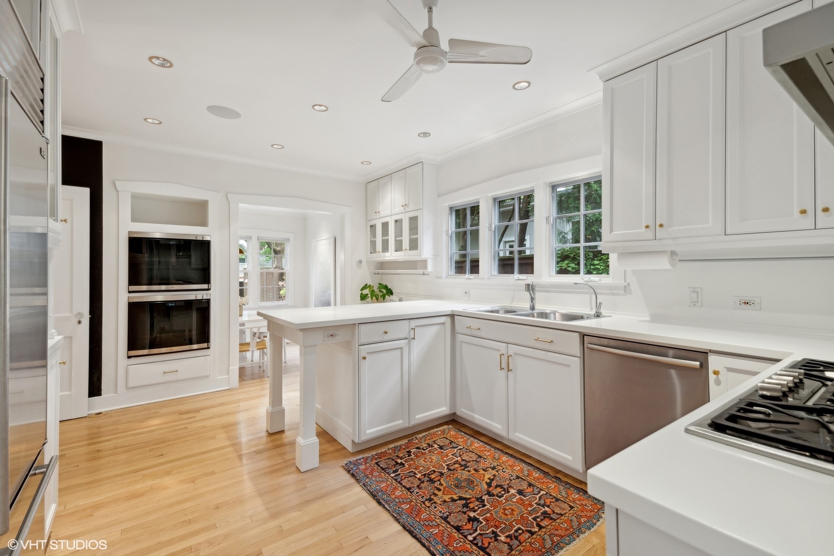 720 Willow Road Winnetka, IL 60093 - Photo 14 of 60 a kitchen with granite countertop a stove a sink and a refrigerator