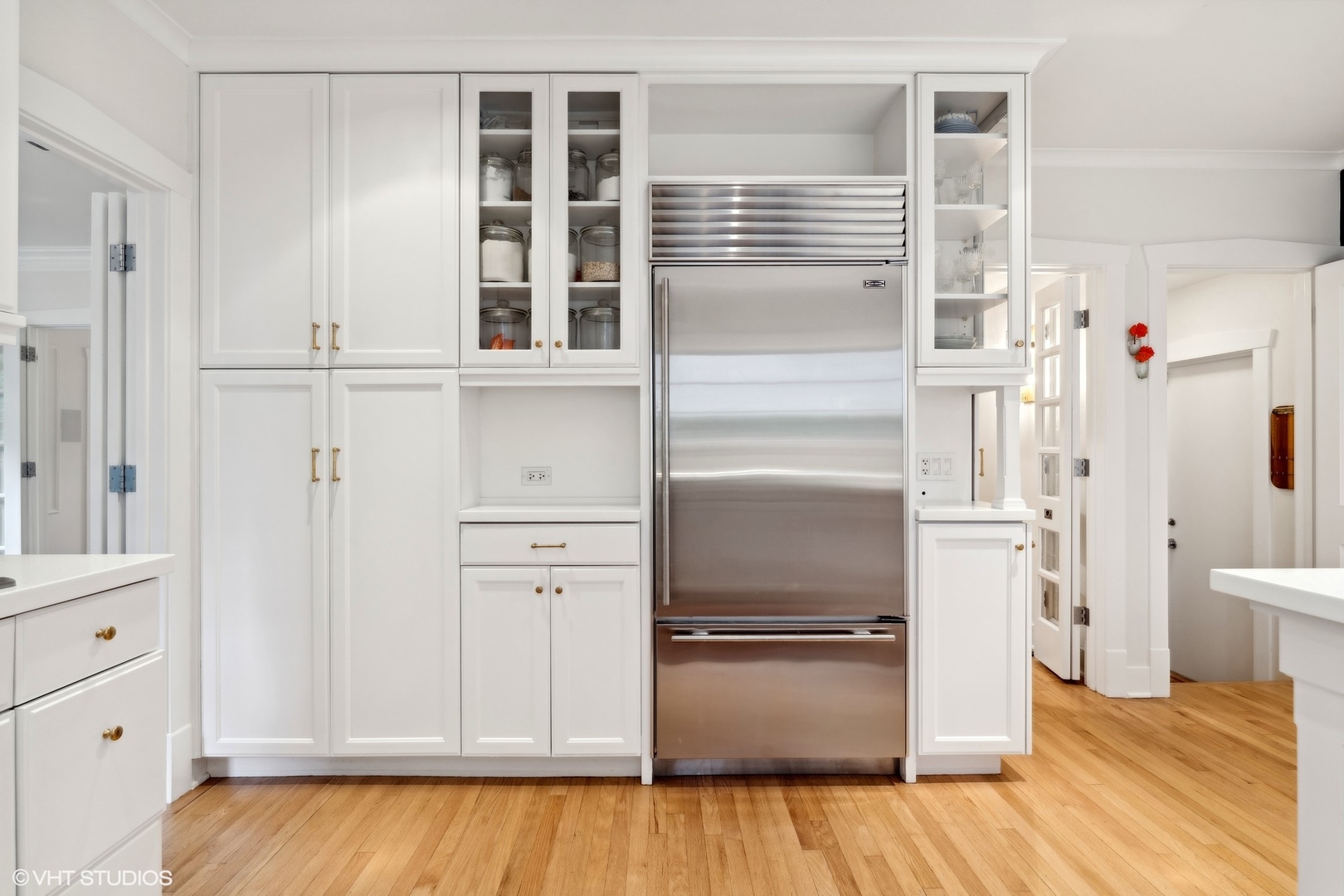720 Willow Road Winnetka, IL 60093 - Photo 15 of 60 a kitchen with white cabinets and refrigerator