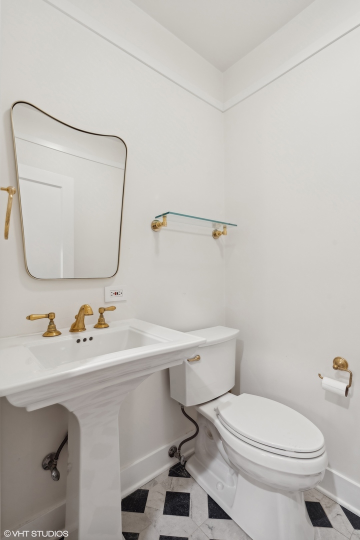 720 Willow Road Winnetka, IL 60093 - Photo 22 of 60 a bathroom with a sink a toilet and mirror