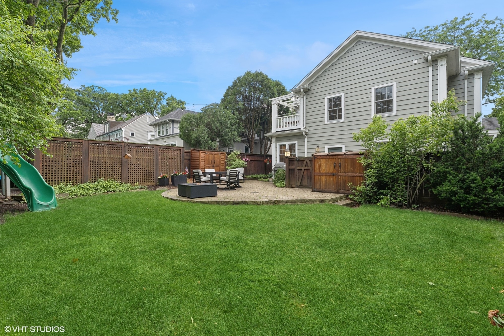 720 Willow Road Winnetka, IL 60093 - Photo 51 of 60 a backyard of a house with table and chairs