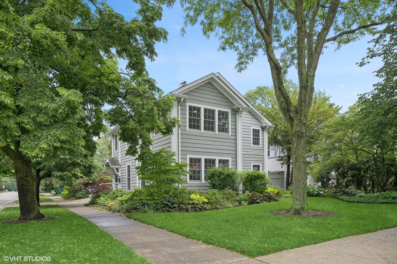 720 Willow Road Winnetka, IL 60093 - Photo 60 of 60 a front view of a house with a garden
