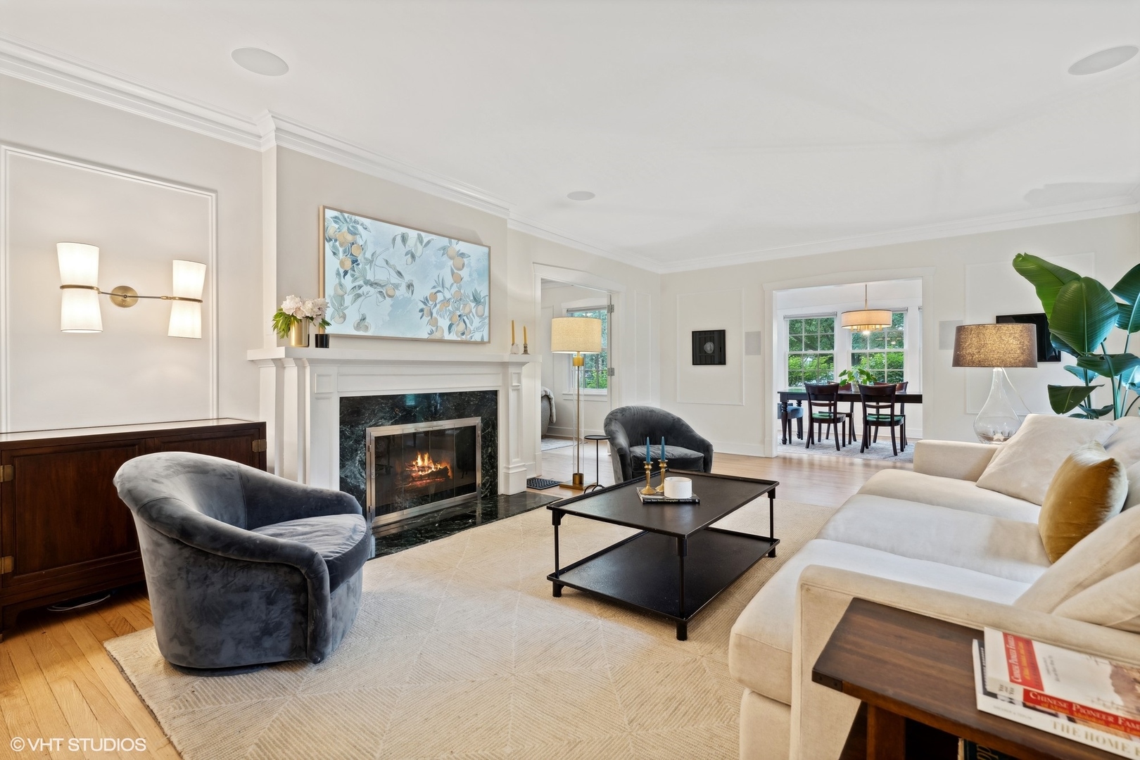 720 Willow Road Winnetka, IL 60093 - Photo 6 of 60 a living room with furniture a rug a fireplace and a window