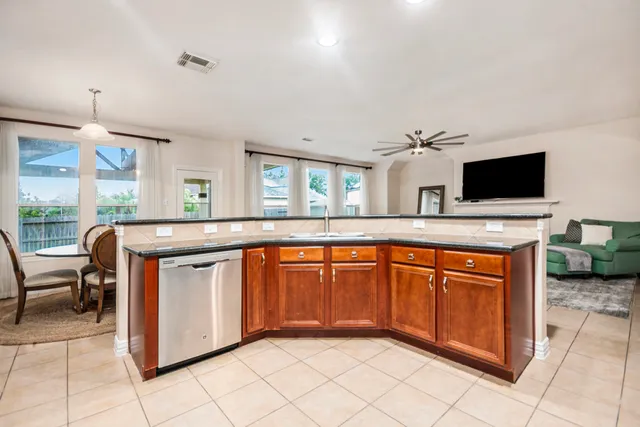 a kitchen with stainless steel appliances granite countertop a sink and a stove