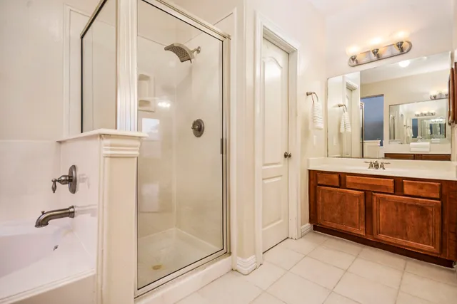 a bathroom with a granite countertop sink mirror and shower