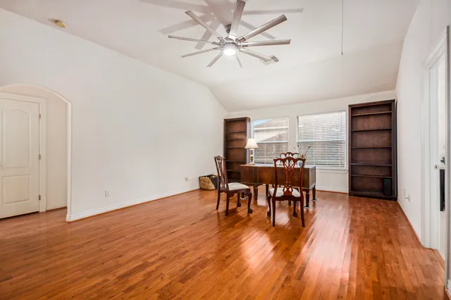 a dining room with furniture and wooden floor
