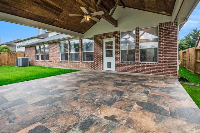a view of a house with a yard and potted plants