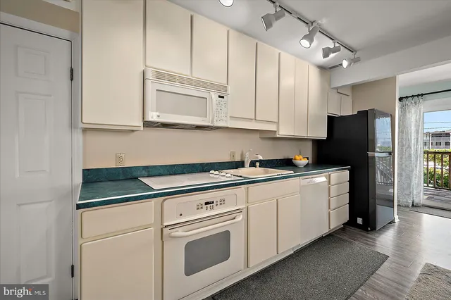 a kitchen with a refrigerator and a stove