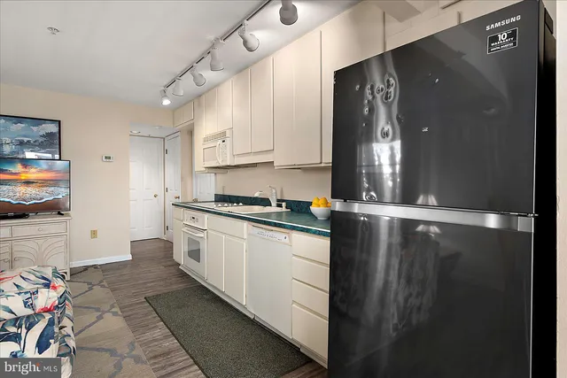 a view of a dining room with furniture a chandelier and wooden floor