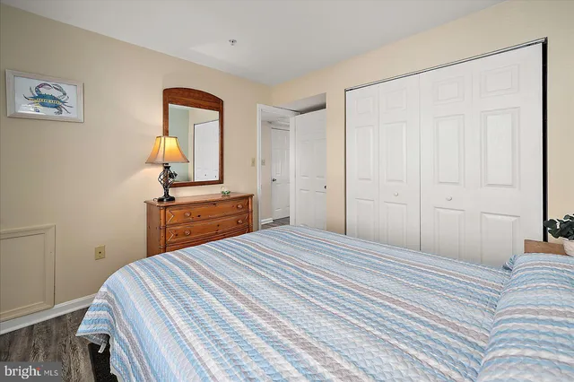 a spacious bedroom with a bed and a flat screen tv