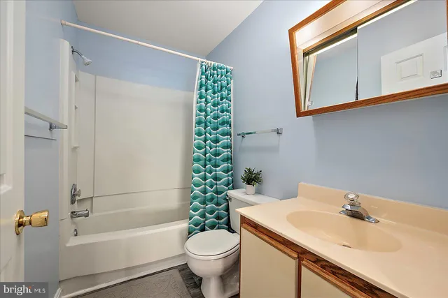 a bedroom with a bed and a night stand