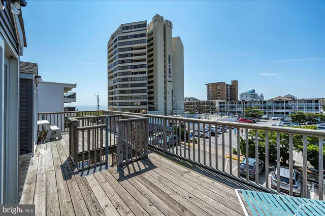a view of a balcony with chairs and potted plants