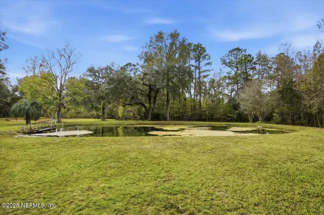 a view of a swimming pool with an outdoor space and seating area