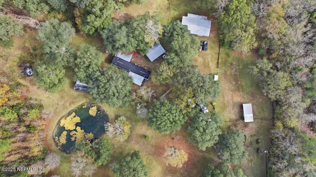 an aerial view of a house with a yard
