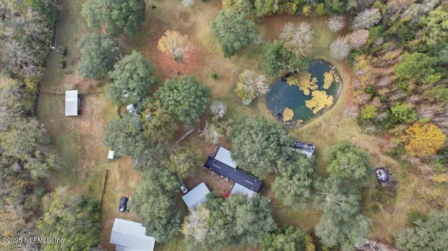 an aerial view of a house with yard and outdoor seating