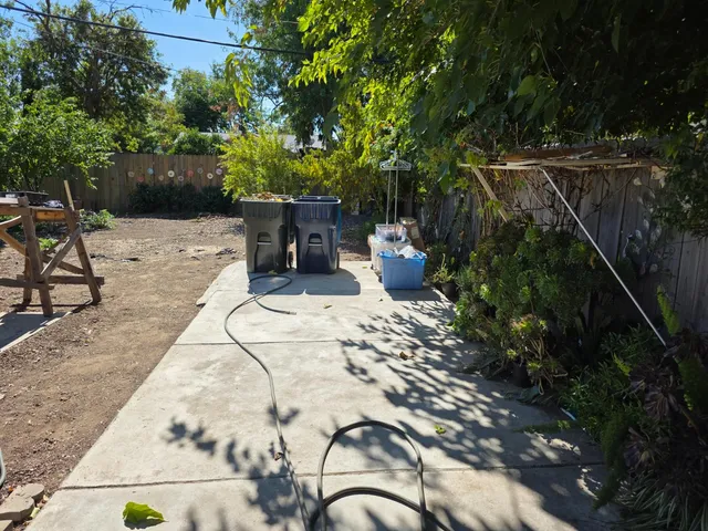 a view of backyard with a table and chairs
