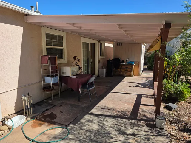 a living room with furniture a dining table and a potted plant