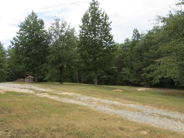 430 Pioneer Road Macon, GA 31217 - Photo 22 of 23 a view of a field with trees in the background