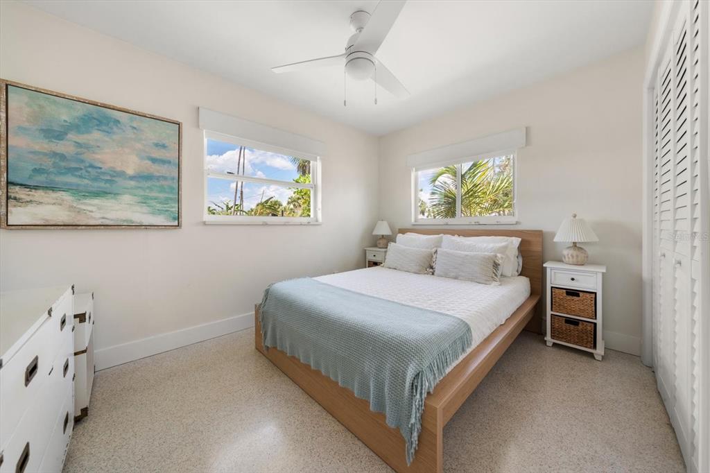 127 11th Avenue Indian Rocks Beach, FL 33785 - Photo 14 of 63 a bedroom with a bed and a chandelier